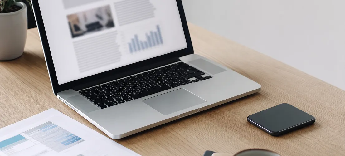 Escritorio con portátil mostrando contenido listo para distribuir mediante publicidad de marca