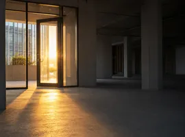 Entrada iluminada de un edificio hacia un espacio interior vacío, metáfora de tráfico sin confianza de marca
