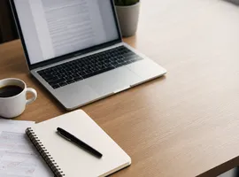 Escritorio con borrador impreso y ordenador, representando el control humano sobre el contenido generado con IA