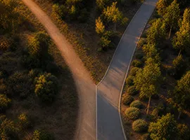 Dos caminos que convergen, representando la combinación de leads orgánicos en redes y publicidad social pagada